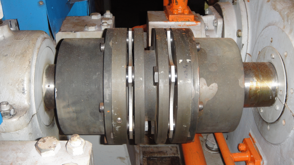 Metallic disc coupling connecting two rotating shafts, illustrating one of the types of coupling used to absorb axial and angular misalignments.